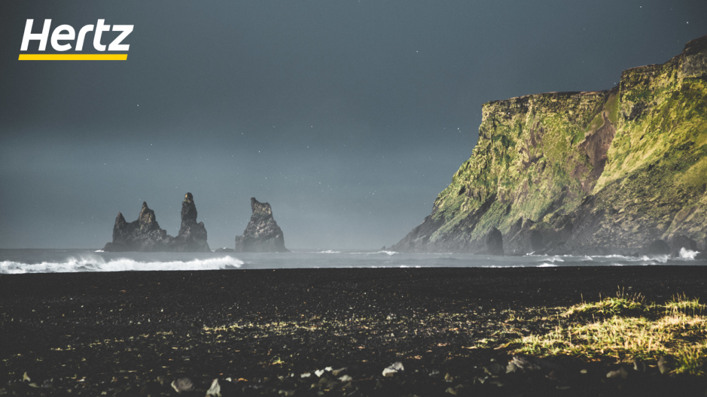 a view from the black sand beach next to the Icelandic town Vik