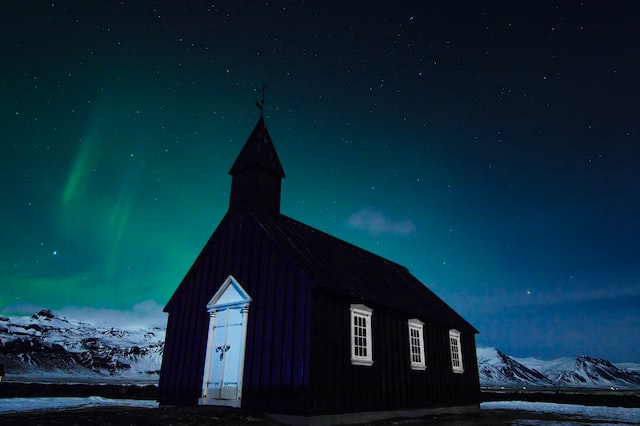 black church with northerng light in Iceladn 