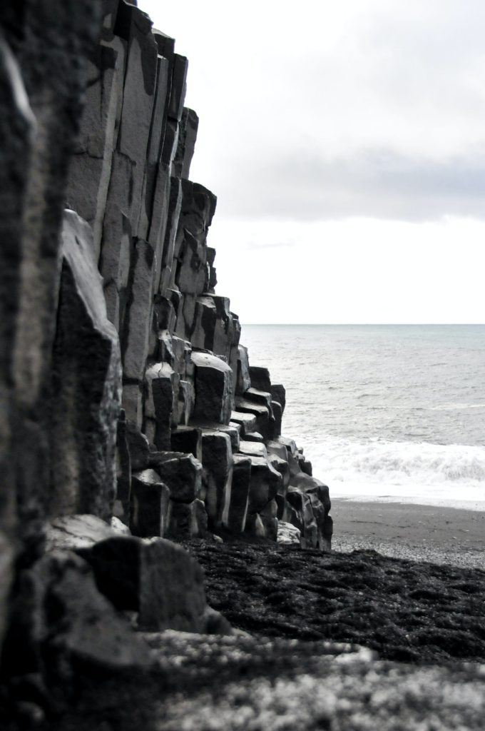 the hexagonal basalt columns  can be found on black sand beach 