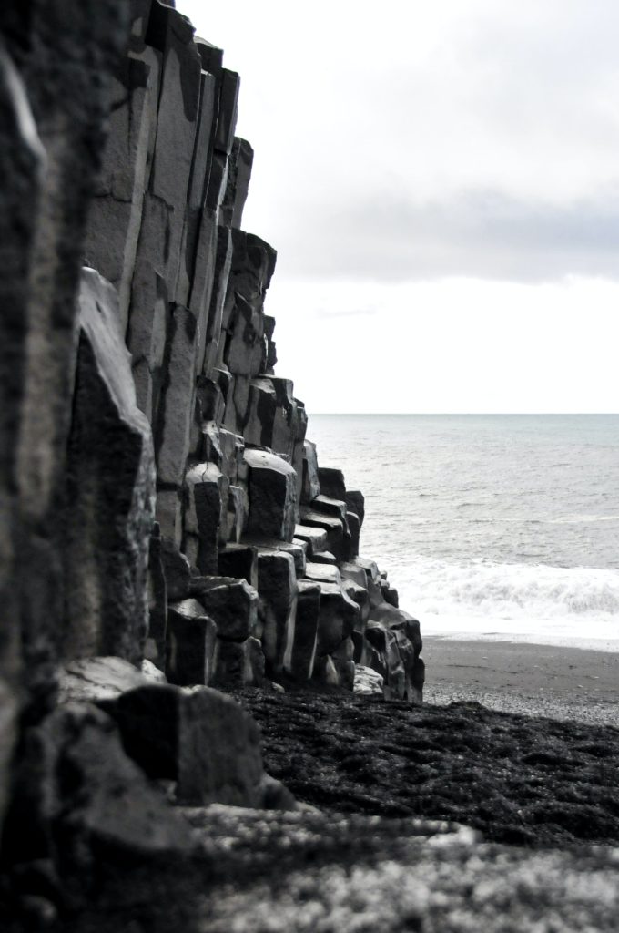 the hexagonal basalt columns can be found on black sand beach