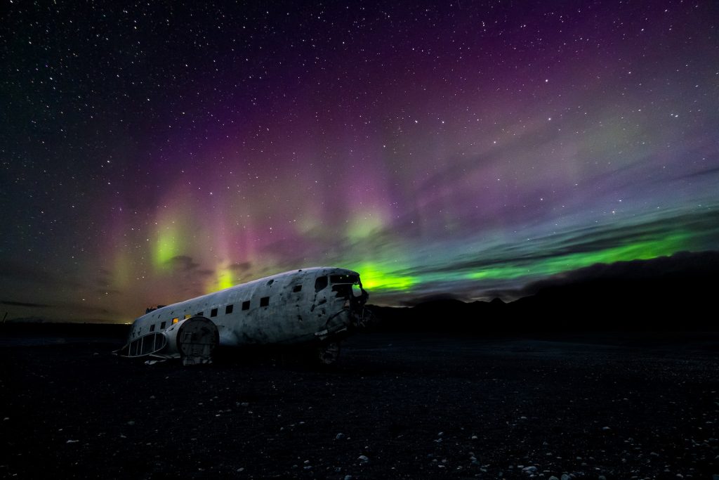 the plane wreck in iceland under aurora
