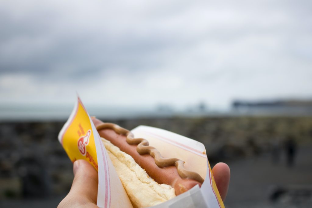 eat a hot dog on the Iceland black sand beach
