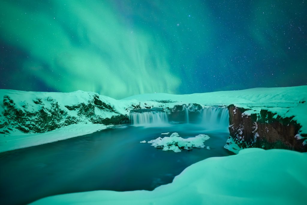 The Aurora with snowy winter view in the north Iceland