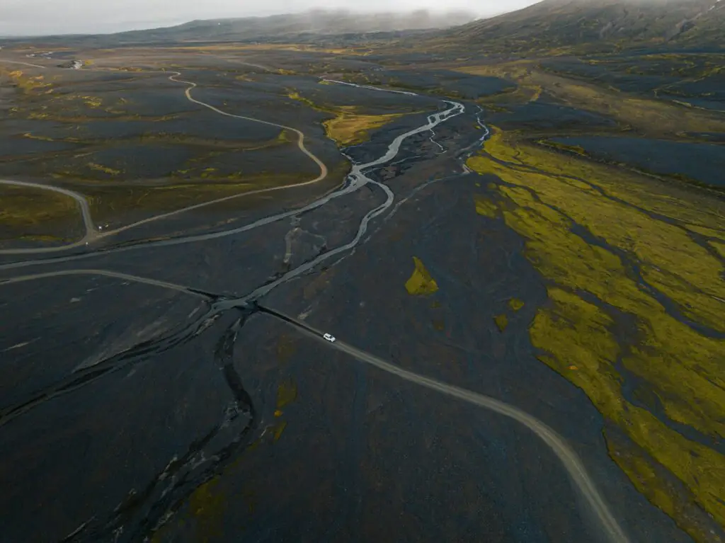 driving through glacier river in iceland highland