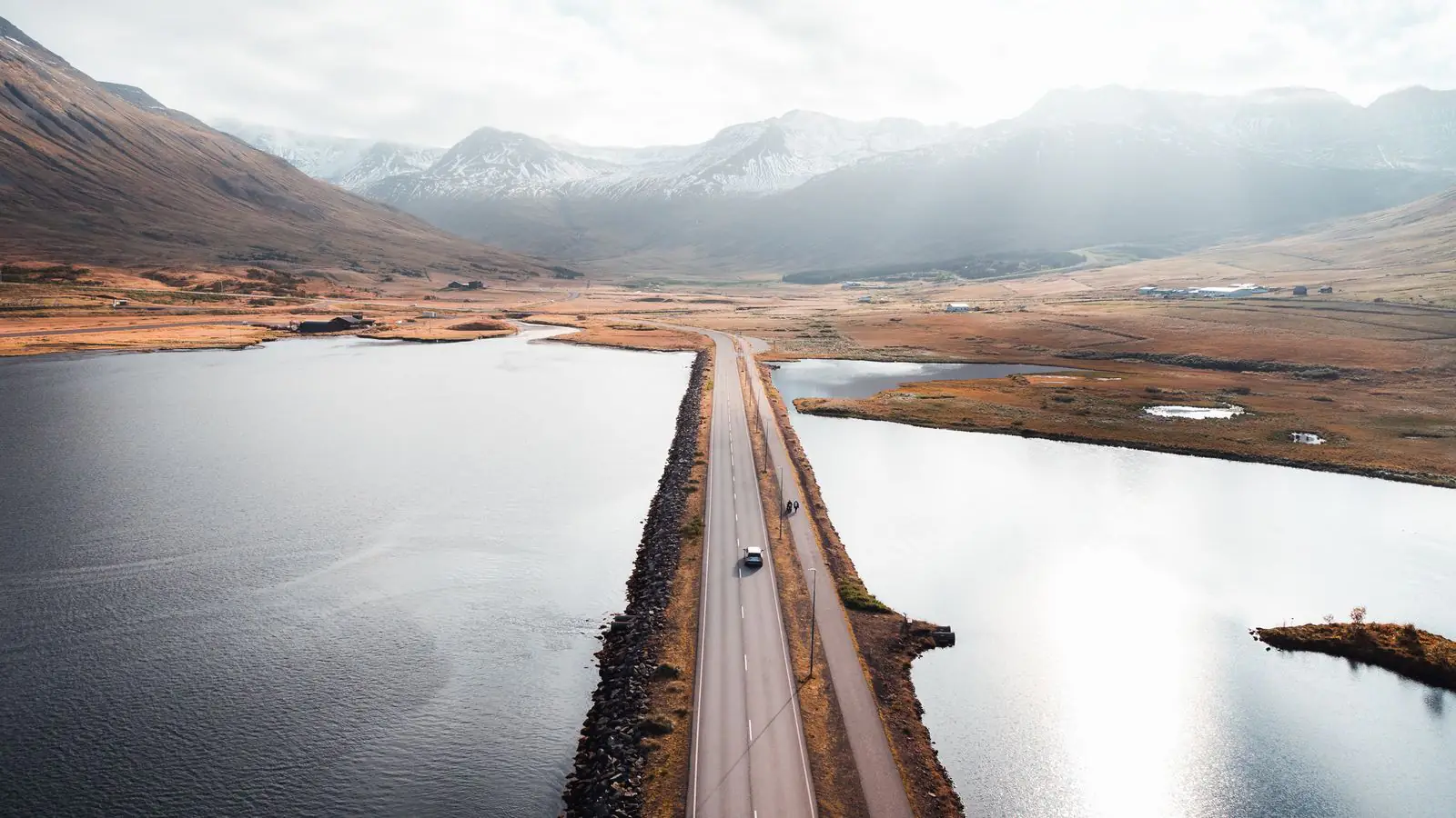 Hertz rental car on a scenic Icelandic road between mountains and sea