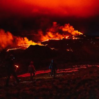 the cloud is painted red by the erupting volcano in Iceland